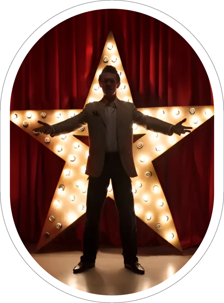 A man standing in front of a star on stage.